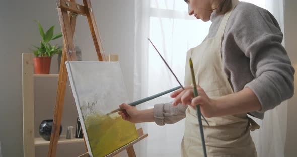 Creative Hobby and Entertainment at Weekend and Selfisolation Woman Is Painting Landscape on Canvas alt