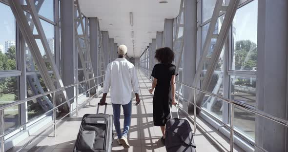 Back View of African Young Woman and American Black Man Walk Together Talking, Mixed Race Couple alt