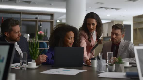 Multi Ethnic Emlpoyees Working Together Using Computer Analyzing Data on Meeting alt