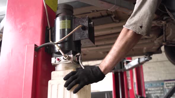 auto mechanic raises the car on a lift. diagnostics. car workshop alt