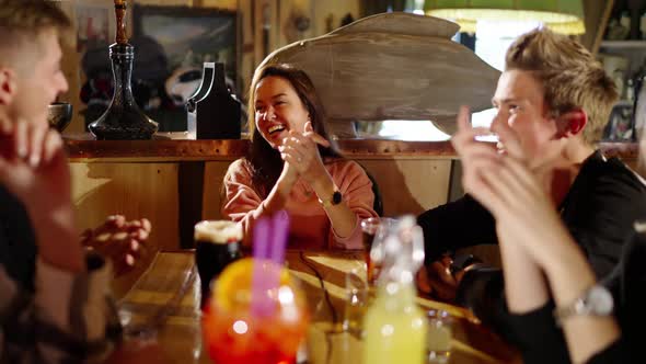 Group of Happy Multiethnic Friends Having Fun Together Drinking Bottled Beer in a Bar or at Home alt