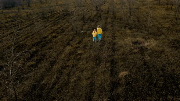 Ukrainian Girls in Clothes in the Colors of the Ukrainian Flag on the Ground alt