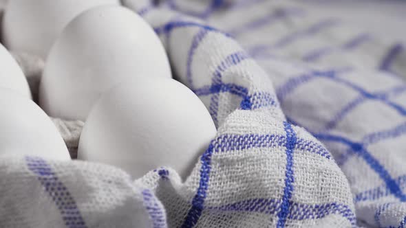 Lots of Fresh Raw Chicken Eggs in a Cardboard Box Rotating Shot Chicken White Fresh Raw Eggs on a alt