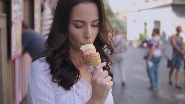 Beautiful Brunette Woman Eating Delicious and Sweet Ice Cream