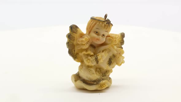 Beautiful Little Angel Statuette on a White Background 