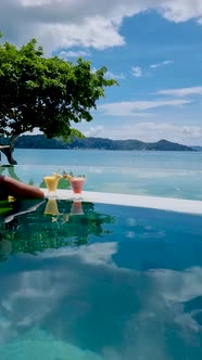 Woman Relaxing at the Pool Asian Woman at Pool Cocktails on a Edge of an Infinity Pool of an Luxury alt