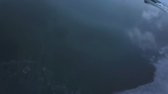 Flight over a lake with ice and snow on it. alt