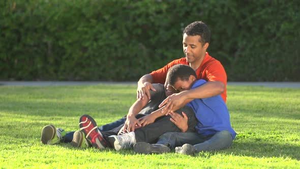 Group portrait of a father and his sons with a football. alt