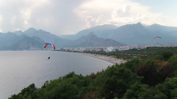 Paragliding Over Sea With View Of Mountains And Green alt