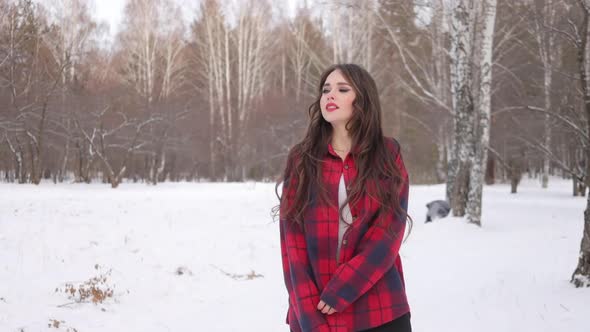 Charming Female with Long Hair Walking in Snowy Forest