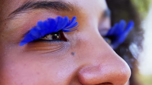 Woman in blue eye lashes at music festival 4k alt