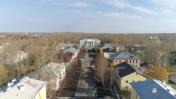 Aerial view of construction of road and sidewalks with flower beds in city 16 alt