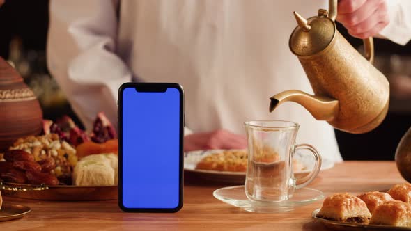 Turkish Sweet Food and Phone with Blue Chroma Key Screen alt