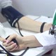 Female Doctor Measures The Blood Pressure Of Men In The Office - VideoHive Item for Sale