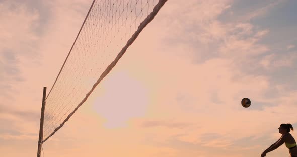 Beautiful Bikini Girls on the Beach Play Volleyball in Slow Motion. alt