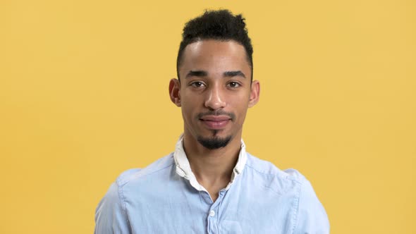 Portrait of Pleased Man with Arabic Appearance in Shirt Looking on Camera and Smiling Isolated Over alt