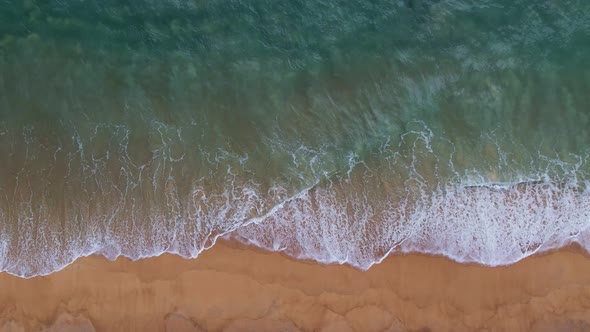 Aerial view Drone camera top down of sea waves in ocean. Turquoise sea surface Amazing sea waves alt