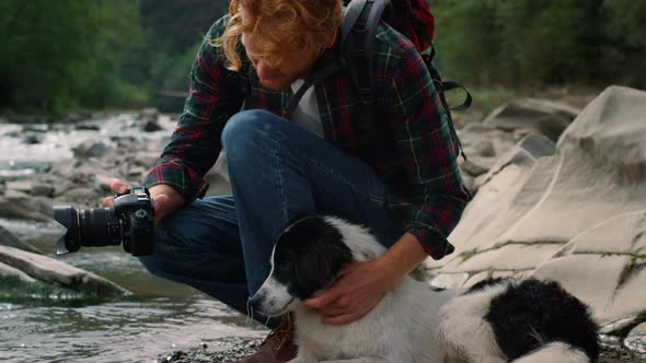 Photographer Showing Dog Photos on Camera alt