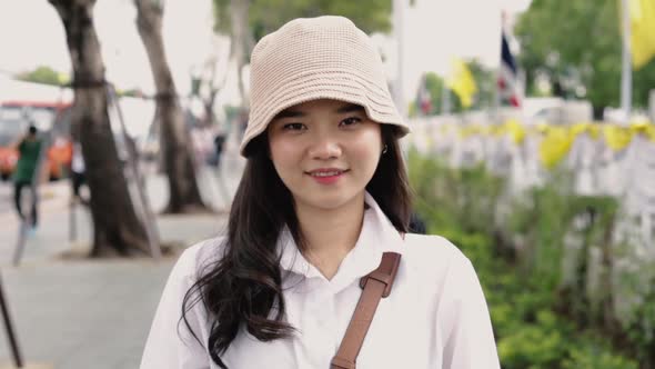 Happy portrait attractive young Asian woman smiling looking at the camera.