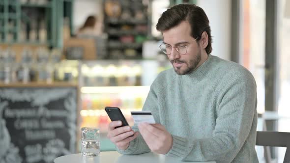 Successful Online Payment on Smartphone By Young Man alt