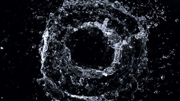 Super Slow Motion Shot of Rotating Water Ring Moving Towards Camera at 1000Fps alt