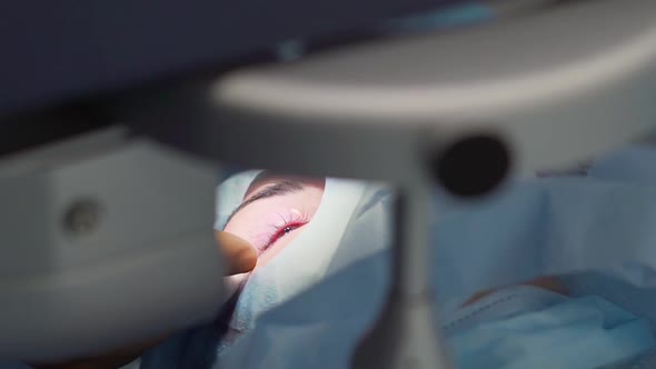 The Doctor Wipes the Patient's Eye After Surgery  Laser Vision Correction alt