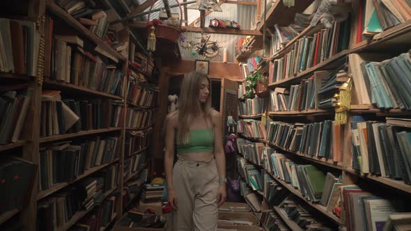 KIEV UKRAINE  JULY 15 2021 Blonde Walk Abandoned Old Library Wooden Shelves Rare Books