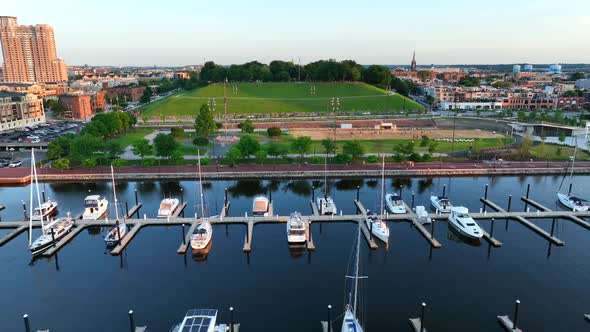 Federal Hill in Baltimore Maryland. Sand volleyball court at sunset. Aerial dolly shot over boat doc alt