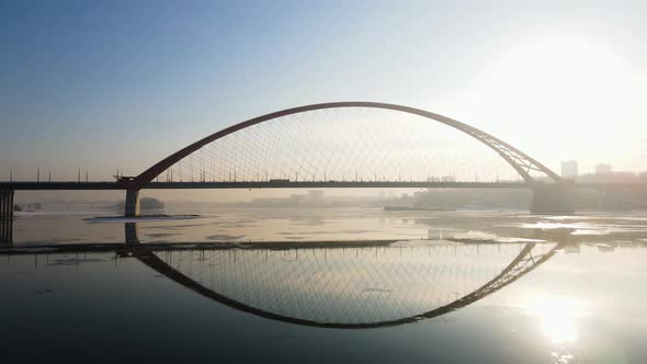 Flight Under the Bugrinsky Bridge in Novosibirsk at Sunset in Winter alt