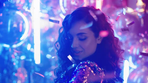 Sweet Woman Making Movements in Nightclub in Slow Motion. Girl Dancing at Party alt