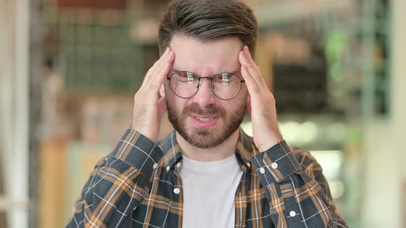 Portrait of Tired Young Man Having Headache alt