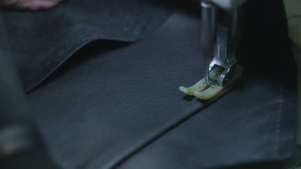 Closeup of Sewing a Needle Seam on a Black Leather Jacket on a Sewing Machine alt