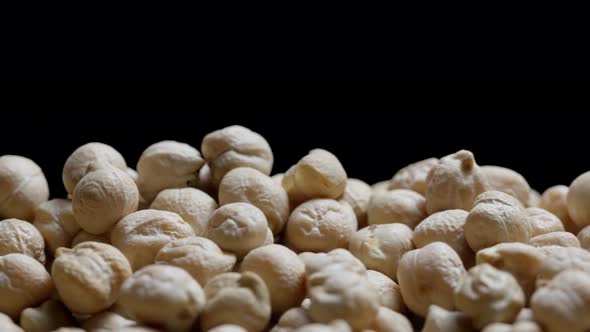 Close up of a bunch of chickpeas on a black background, dry chickpeas  abstract background