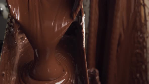 Melted chocolate pouring in a candy factory