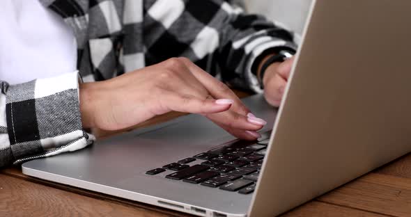 Businesswoman or student girl hands with laptop computer sitting at table.