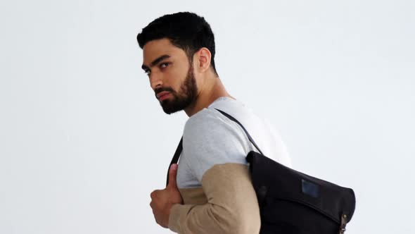 Man with bag standing against white background 4k alt