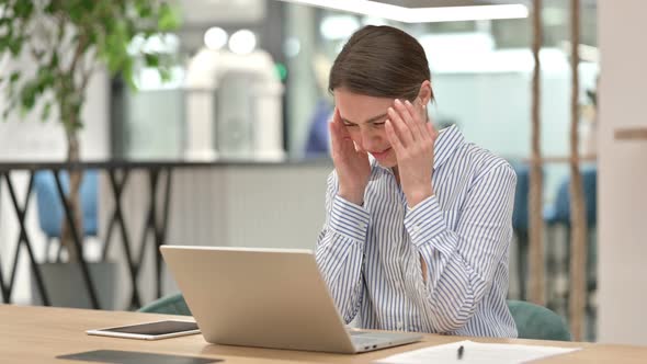 Stressed Woman with Laptop Having Headache in Office  alt