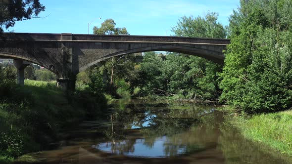 AERIAL Towards Historic Cement Arched Bridge Over Moorabool River Geelong alt