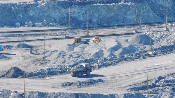 Big Yellow Trucks Transport Ore in an Asbestos Mineral Quarry alt