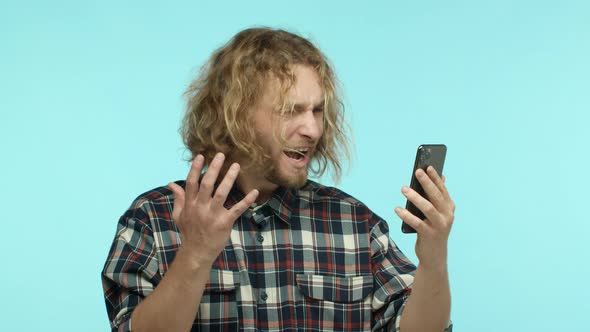 Slow Motion of Frustrated Handsome Guy Looking at Smartphone Screen Then Asking What Shouting Upset