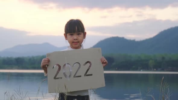 Little girl holding of new year 2022. alt