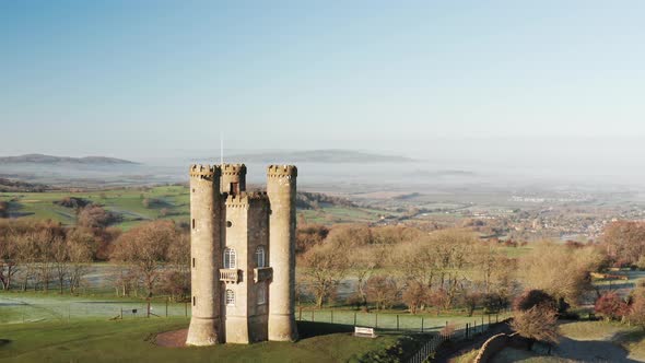 Aerial drone video of Broadway Tower, a famous old building landmark in The Cotswolds Hills, iconic  alt