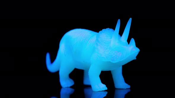 Green Toy Dinosaur Turning Agaisnt Black alt