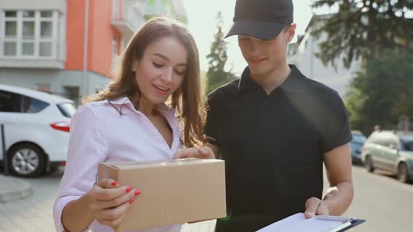 Delivery Service. Woman Receiving Package From Courier alt