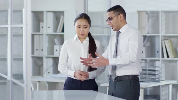 Multiethnic Colleagues Discussing Invisible AR Object alt