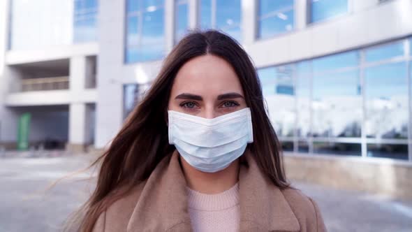 Portrait of a Young Woman Wearing Protective Mask on Street. The Concept Health and Safety, N1H1