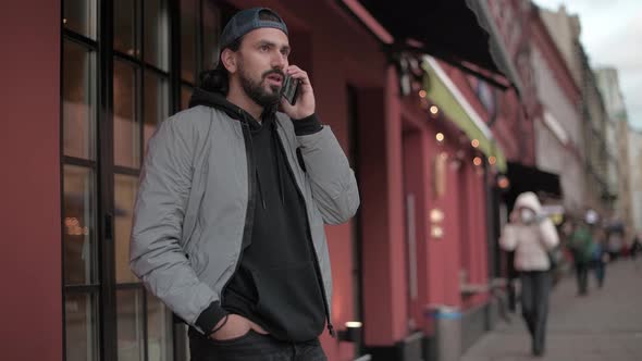 Young Modern Handsome Man Talking on the Phone of Sunny Spring Day alt