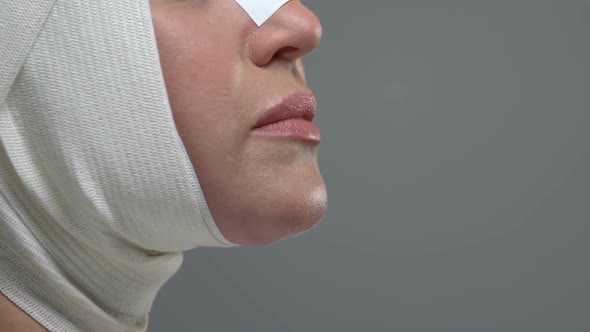 Side View of Woman Face Wearing Elastic Bandage, Plastic Surgery Rehabilitation