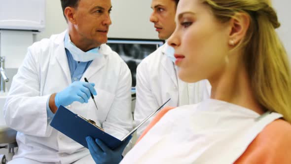 Portrait of smiling female patient sitting on dental chair alt