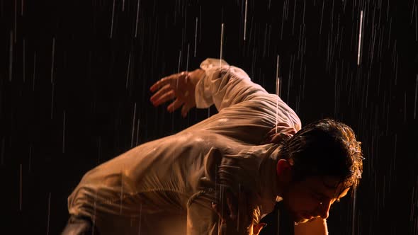 A Sexy Couple Moves to the Beat of the Music in the Pouring Rain and Then Lies on the Surface of the alt